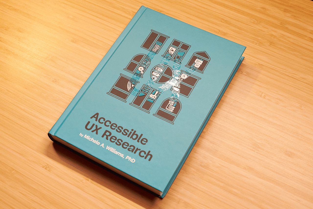 Hardcover edition of Michele Williams&rsquo; new book &ldquo;Accessible UX Research&rdquo; on a wooden table.